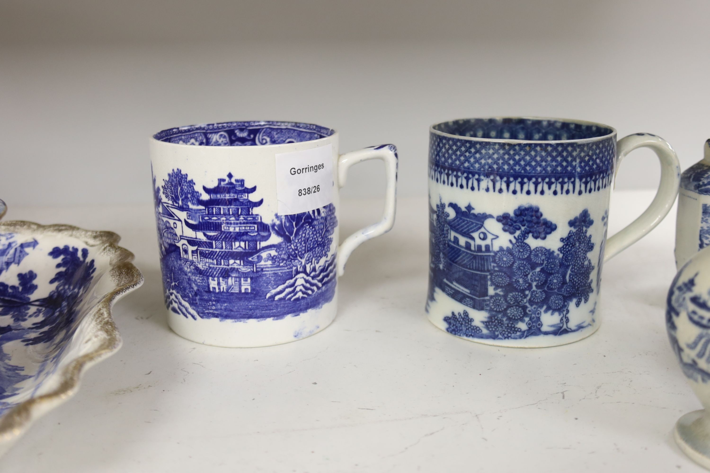 A collection of English blue and white pottery, various dates, comprising a moulded hexagonal teapot and cover, with widow finial, ovoid teapot and cover, lozenge section sugar bowl and cover, with swan finial, circular